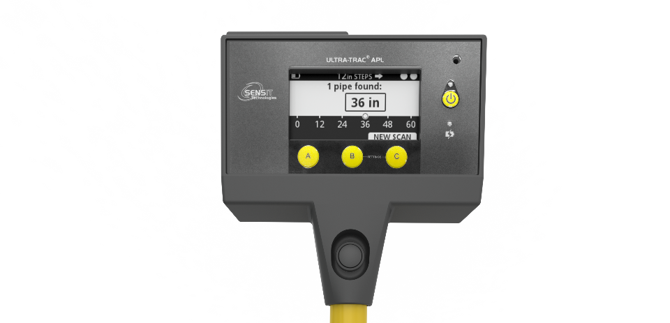 Acoustic pipe locator, top-down view. Round, bright yellow metal tubing extends from a small rectangular analog screen accompanied by round yellow buttons.