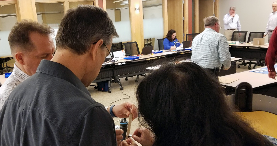 Attendees work on a physical prototype.